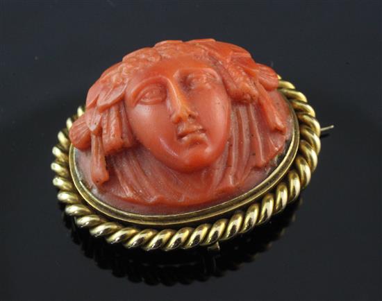 A late 19th century gold mounted coral brooch, 1.5in.